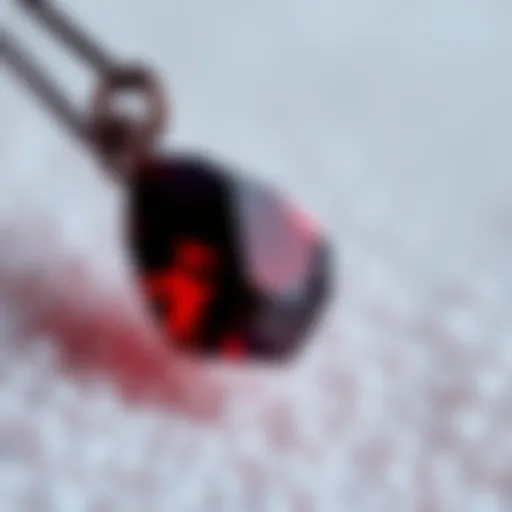 A close-up of a blood garnet charm displaying its deep red color and natural texture, set against a soft background.