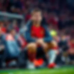 Edin Dzeko sitting on the bench with a bandaged leg, looking concerned during a football match