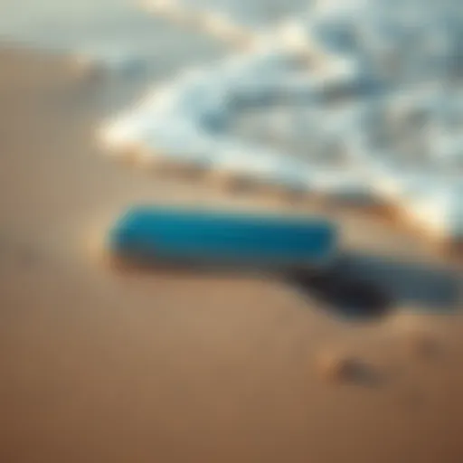 iPhone Duo resting on wet sand with ocean waves