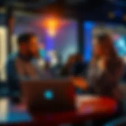 A man and a woman actively chatting about securing an event location, with a laptop open on a table between them