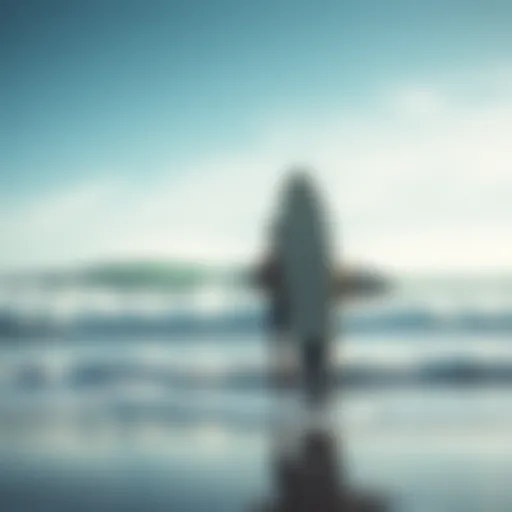 A surfer stands on the beach holding a big wave surfboard, ready to tackle large waves.